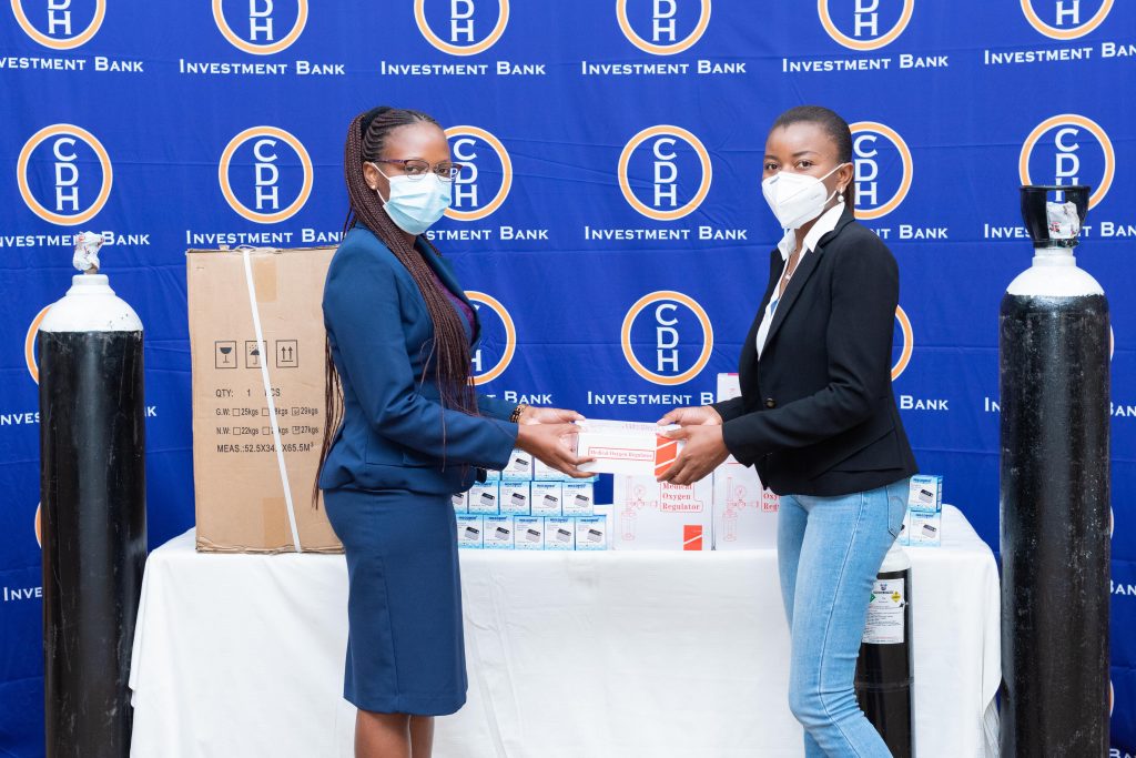 CPS Pension Services Manager Mrs. Makhumbo Chikaonda making a symbolic handover to SMD representative Dr. Winnie Mhone