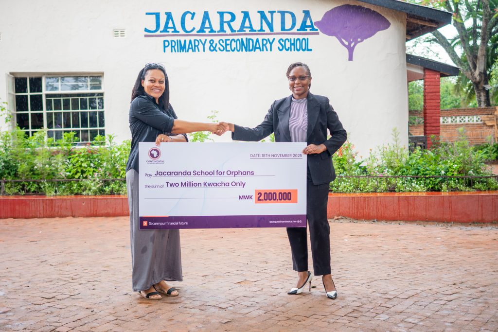 Chikaonda (right) presenting the symbolic cheque to Ferreira (left)